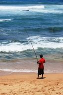 lonely fisherman on the beach