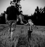 father and child go for hands black and white photo