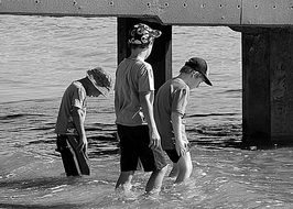 Black and white photo of thw boys in water