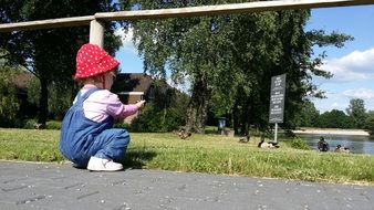 baby near the duck pond