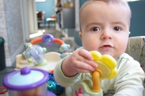 portrait of baby boy with toy