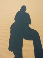 human shadow on sand dune