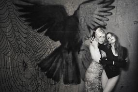 sexy women painting of eagle on wall