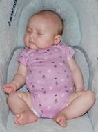 newborn girl sleeping in a chair