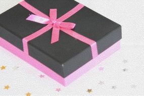 black and pink gift box with a pink bow