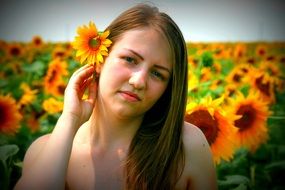 portrait of girl with a sunflower in her hair