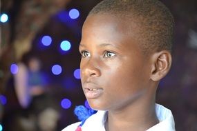 black boy on christmas lights background