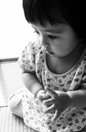 black and white photo of a little girl on the chair