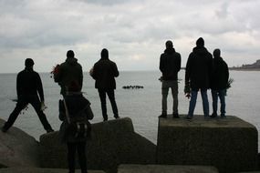 a group of people on concrete blocks, scheveningen