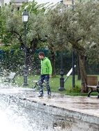 man in a yellow jacket in a spray of water