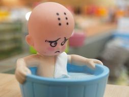 miniature figure in the toy bath