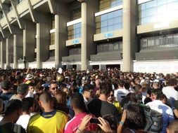crowd of people in a stadium on a sunny day