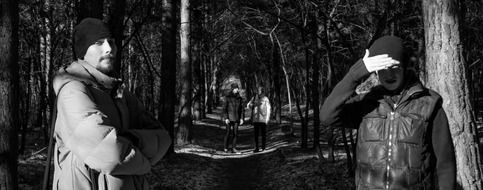 black and white photo of people in the forest