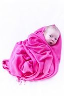 baby wrapped in a pink blanket