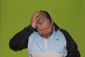 Man with white sheets in thought