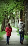 mother and daughter walking in park