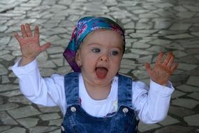 blue eyed baby girl leaned against the window