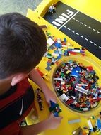 child plays Lego