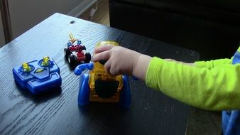 child plays with plastic toys