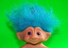 troll doll toy on a green background