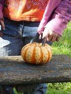 dirty child hand touching pumpkin