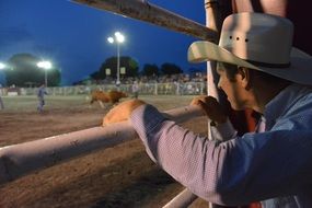 cowboy watching rodeo show