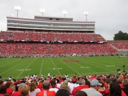 full stands of spectators at the match on the American football