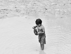 street boy in the pond