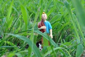 tintin, figurine of comic character in green grass