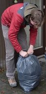Man is taking out the garbage