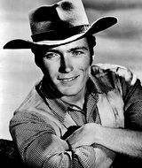 black and white photo of smiling Clint Eastwood in a cowboy hat