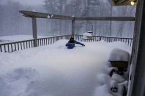 boy in big bank of snow