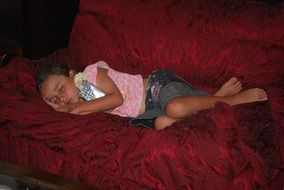 sleeping baby on a dark couch