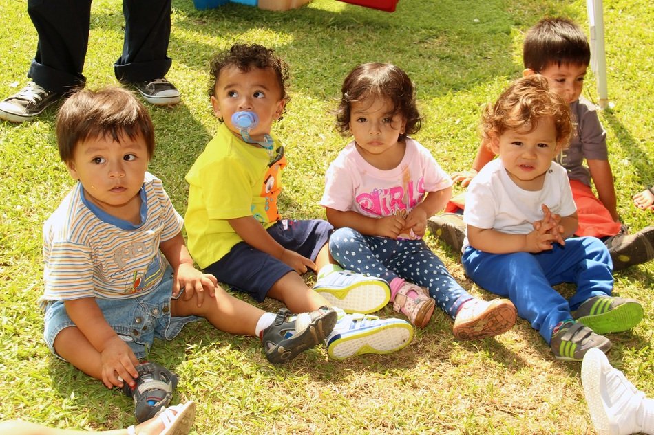 small children on the lawn in the park