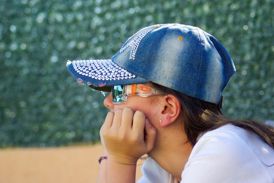 girl in a cap and glasses in the summer