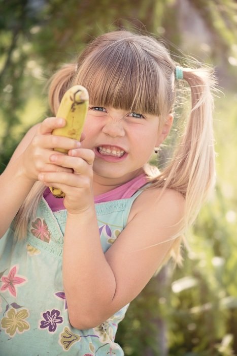 funny girl blond with banana in hands