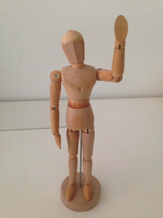 wooden man on the windowsill