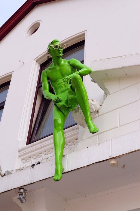 green man figure in the building facade
