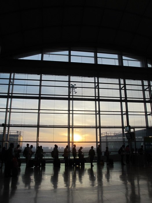 dark silhouettes of people at the airport