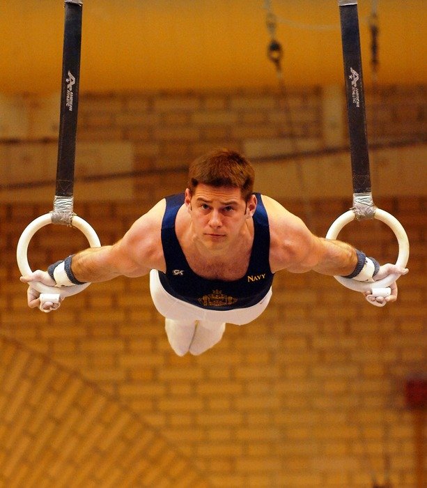 athlete on the sport rings in the gym