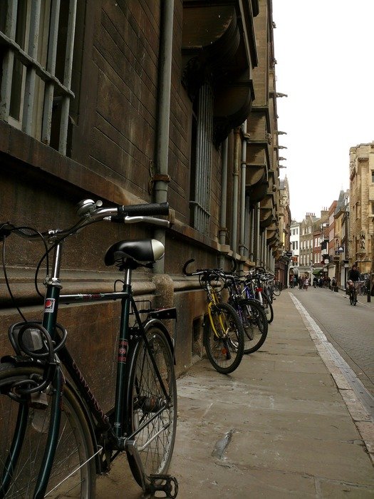 bikes near the wall of the University of Cambridge