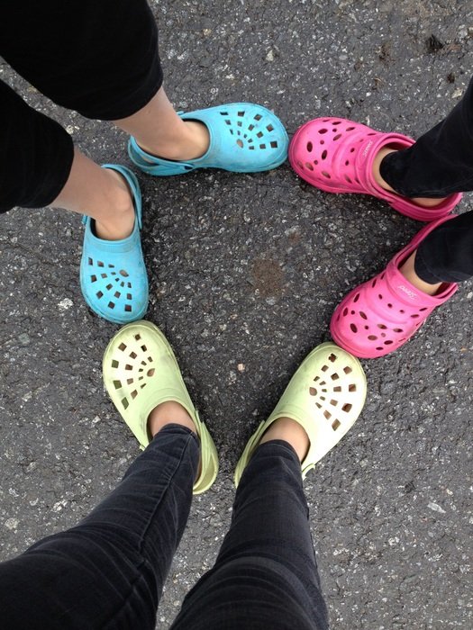 Children with colorful croksits on their legs