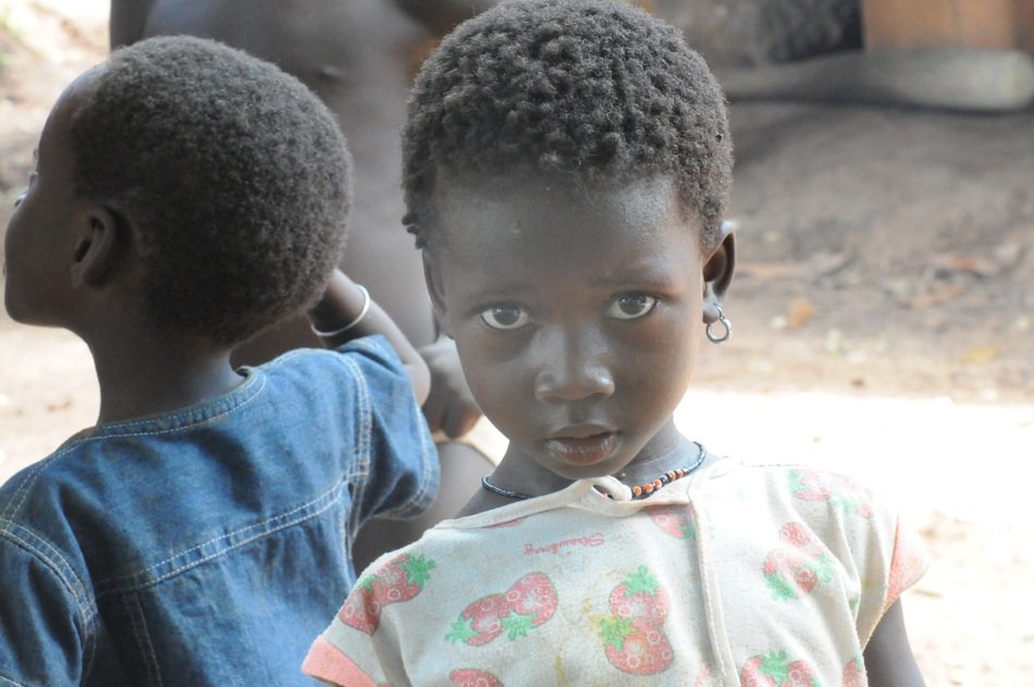 beautiful African girl with earrings near the other African child
