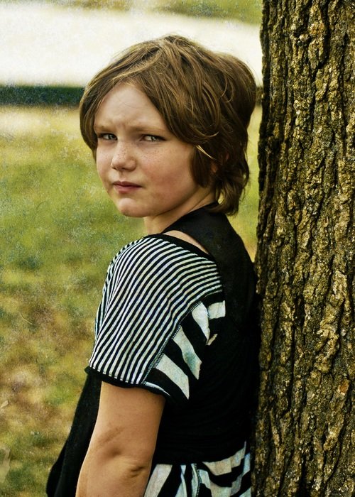 Child next to tree