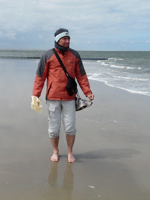 Man on a wet sandy beach