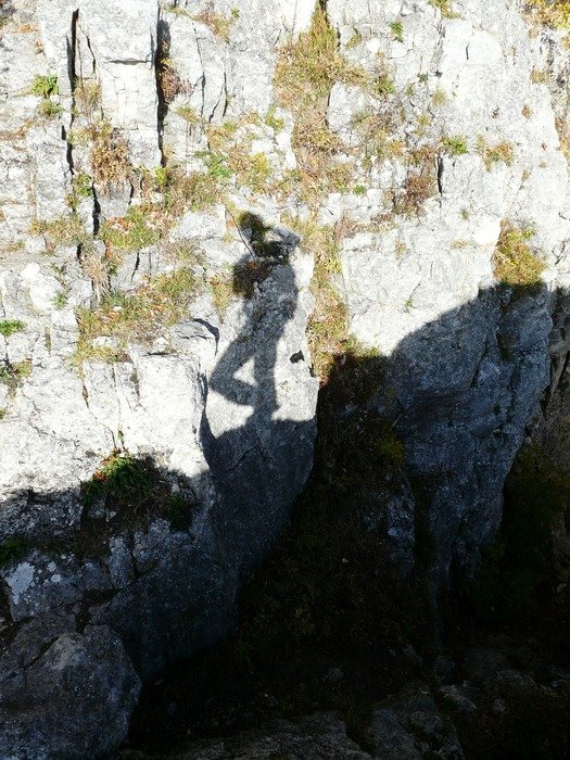 shadow play in the form of a human on a rock