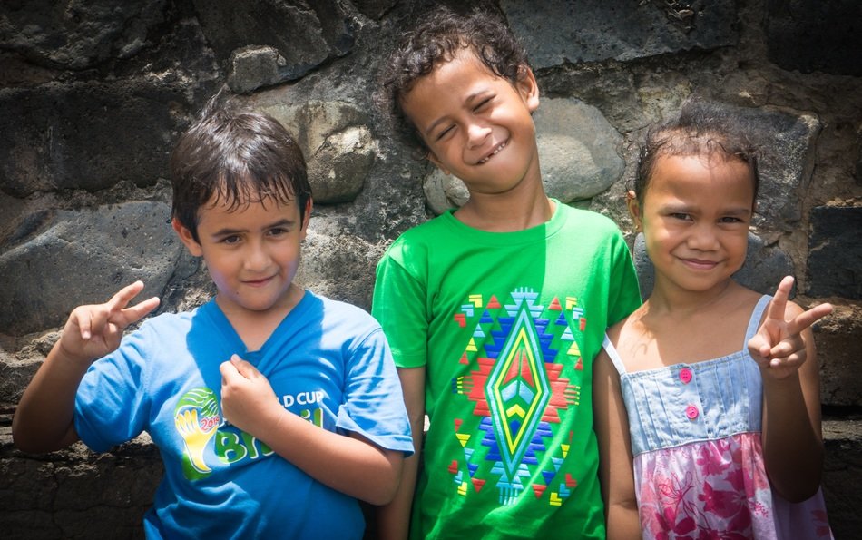 three happy children in french polynesia