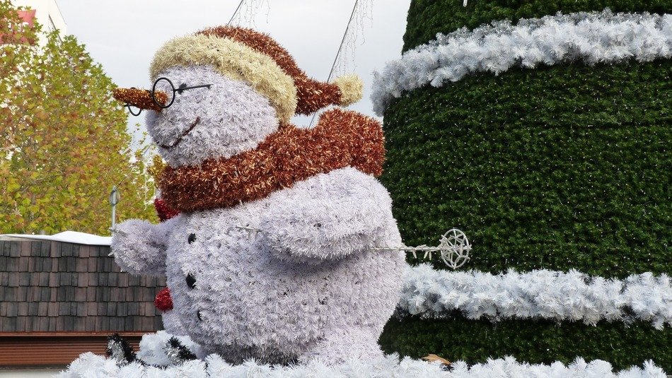big snowman with glasses on the street