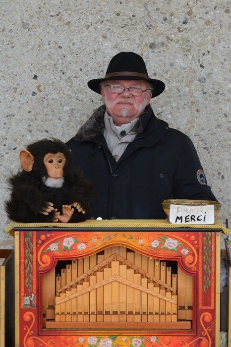 Old man with a monkey at the organ