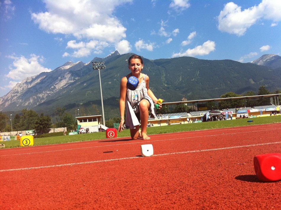 girl rolls dice on the field